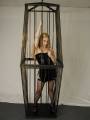 Asley in a large steel cage picture.